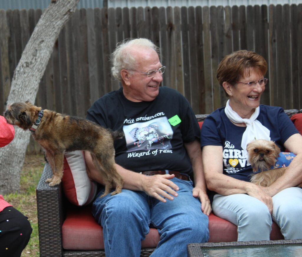 A woman and her dog wearing matching shirts.